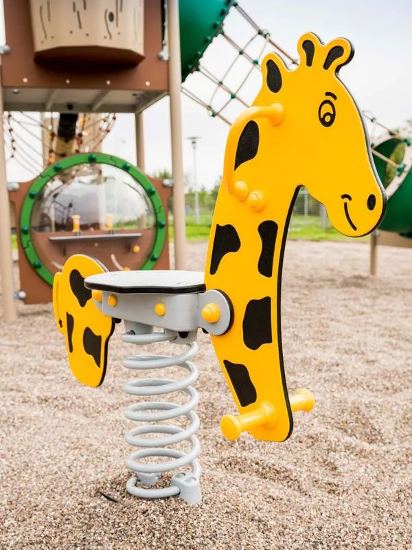 Federwipptier Giraffe auf einem Spielplatz Federwipptier Giraffe auf einem Spielplatz